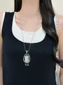 Close-up of elegant silver long necklace featuring a pearl flower pendant on model - Silver Pearl Abacus
