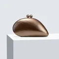 Detail of acrylic evening clutch with dark wood texture and gold spherical clasps - Bronze