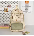 Close-up of cream school bag with cartoon bear prints and transparent mesh front pocket - Yellow