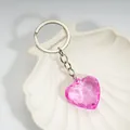 Pink heart-shaped acrylic crystal keychain displayed in a white shell-shaped tray - Rose Red / Silver
