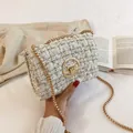 Elegant white tweed chain bag with gold hardware and swivel lock for fashionable women - White