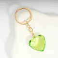 Elegant emerald green heart acrylic keychain with gold chain on display stand - Grass Green / Gold