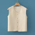 Padded beige quilted warm vest for kids featuring a V-neck and wooden button closure - Vest