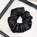 Detail of black velvet scrunchie with sparkling silver rhinestones on a display tray - Mixed-Size Rhinestone Style (Fabric Wrapped)