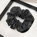 Detail of premium black velvet scrunchie with sparkling silver rhinestones and soft pleats - Straight Strip Rhinestone Style (Fabric-Wrapped)