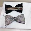 Macro detail of rhinestone bow hair clip showing sparkling stones and metal duckbill grip - AB Iridescent Diamond