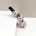 Pink crystal flower banana hair clip with three blossoms on a sleek black resin base - Pink