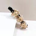 Elegant banana hair clip with champagne crystal flowers on a black plastic base - Champagne