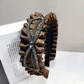 Close-up of brown pleated satin headband with rhinestone bow and crystal detailing - Bow Crystal-Coffee
