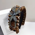 Detailed view of brown satin pleated headband with a sparkling rhinestone flower motif - Bow Flower-Coffee