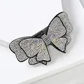 Pasador de pelo con lazo de cristal brillante, base negra y pedrería AB irisada - Doble Capa Strass AB y Blanco