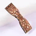 Macro shot of a champagne gold bow hair clip with sparkling rhinestones and crystals - Champagne