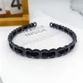 Diadema negra elegante con anillos huecos y tela de lujo entrelazada en plástico pulido - Cadena en Forma de 8 Tejido Brillante / Negro