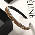 Close-up of luxury thin headband featuring amber crystals and white rhinestones - Light Coffee