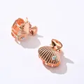 Macro view of shell-shaped rose gold hair claws with iridescent rhinestone accents - Shell Shape