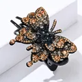 Elegante molletta a farfalla con strass colorati su un supporto bianco minimalista - Grigio Trasparente + Zircone Champagne
