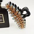 Sparkling rhinestone leaf hair claw clip for thick hair in black resin finish - Champagne