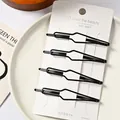 Juego de cuatro elegantes pinzas para el cabello de metal negro en tarjeta de base - Estilo de Gota Hueca