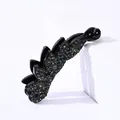 Close-up of black banana clip featuring pavé-set grey rhinestones and blue crystals - Transparent Grey Rhinestone