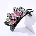 Detail of double-layer butterfly hair claw clip with colorful rhinestones and 3-prong grip - Pink