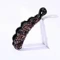 Close-up of sparkling purple rhinestones on a black banana hair clip against white decor - Small Wave Edge / Dark Purple