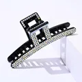 Detail of square black hair claw clip with sparkling colorful rhinestones on white block - Rectangular Colorful Rhinestone