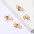 Set of 4 small hollow metal hair claws in polished gold finish on white stone stand - Gold