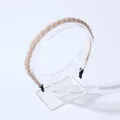 Elegant champagne gold beaded braided headband with non-slip black end tips on stand - Champagne