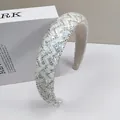 Detail of wide padded headband with silver sequins and intricate beaded wavy textures - White