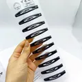 Lot de 10 barrettes à cheveux en métal noir mat présentées sur une carte blanche - 6cm / Oval Shape Glossy