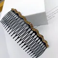 Elegant black hair comb with golden rhinestone wave design on white geometric stand - Double Row Champagne Rhinestone