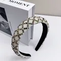 Macro shot of padded headband featuring white pearls and golden rhinestone lattice patterns - Brown Rhinestone