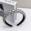 Detail of thickened headband featuring dense white pearls and gray diamond geometric pattern - Transparent Grey Rhinestone