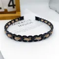 Schicker schwarz-goldener Ketten-Haarreif mit gewebten Details aus Metallic-Garn - 8-Form Kette Goldgewebe / Gold