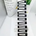 Set of 10 black fabric-covered rectangular BB hair clips on white card display - Square Style