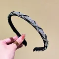 Close-up of a sparkling rhinestone headband with a luxury knotted woven fabric design - AB Zircon