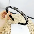 Detailed view of black woven headband featuring intricate sparkling rhinestone lattice pattern - White and Transparent Gray Rhinestone