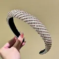 Padded headband with dense pearls and champagne rhinestones in a chic crisscross pattern - Champagne