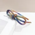 Close-up of rainbow gradient rhinestone headband with intricate bow design details - Light Multi Rhinestone
