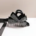 Elegant black hair claw with a large sparkling rhinestone bow design for women - Gunmetal