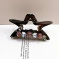 Detailed shot of a brown crystal star hair claw clip with MADE WITH LOVE silver tag - Star Claw Coffee