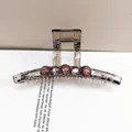 Detailed view of grey translucent hair claw with rhinestone accents and purple beads - Large Square Claw Coffee