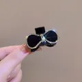 Pinza para el pelo con lazo negro elegante, cristales brillantes y borde dorado - Negro