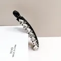 Macro shot of banana hair clip with sparkling heart-shaped K9 crystals and black base - White