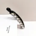 Macro detail of heart-shaped K9 crystal banana clip showing glossy finish and craftsmanship - Light Gray