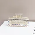 Macro shot of clear acrylic hair claw clip with silver rhinestones and iridescent pearls - Medium-sized Pearl Clip Chain [square Transparent]