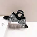 Macro view of the large black bow hair claw clip with shimmering silver rhinestones - Large (HJ-24) / AB Color