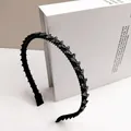 Close-up of black thin headband with rhinestones and non-slip inner teeth for secure hair - S-Shape Style / 1cm Thin Edge