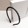 Detail view of a slim black headband with sparkling rhinestones and anti-slip comb teeth - Heart Style / 0.8cm Narrow Brim