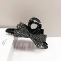 Detailed macro view of a glossy black bow hair claw clip with shimmering rhinestones - Large (HJ-24) / Gun Black